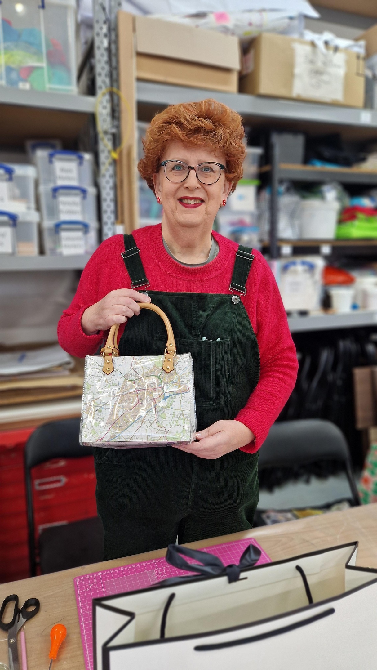 Lady holding a handbag she has made from books